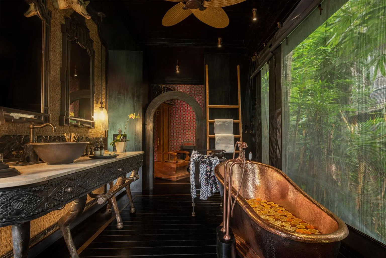 Luxurious bathroom at Capella Ubud, featuring elegant design elements surrounded by tropical rainforest views—part of the 'Awaken to Magic' journey in collaboration with NIHI Sumba.