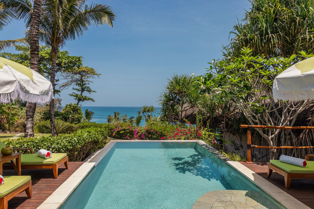 Private plunge pool at Kasambi Villa, surrounded by tropical gardens and overlooking the ocean at NIHI® Sumba.