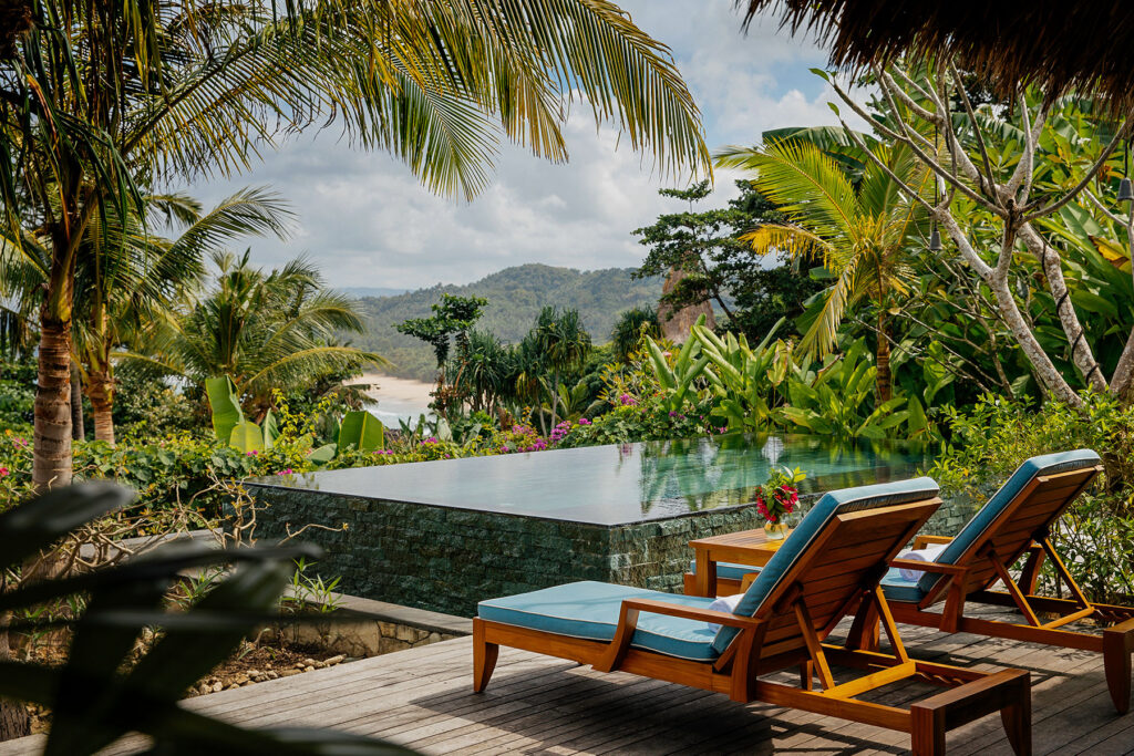 Lulu Amahu Villa’s private pool, with picturesque ocean views in the background at NIHI Sumba.