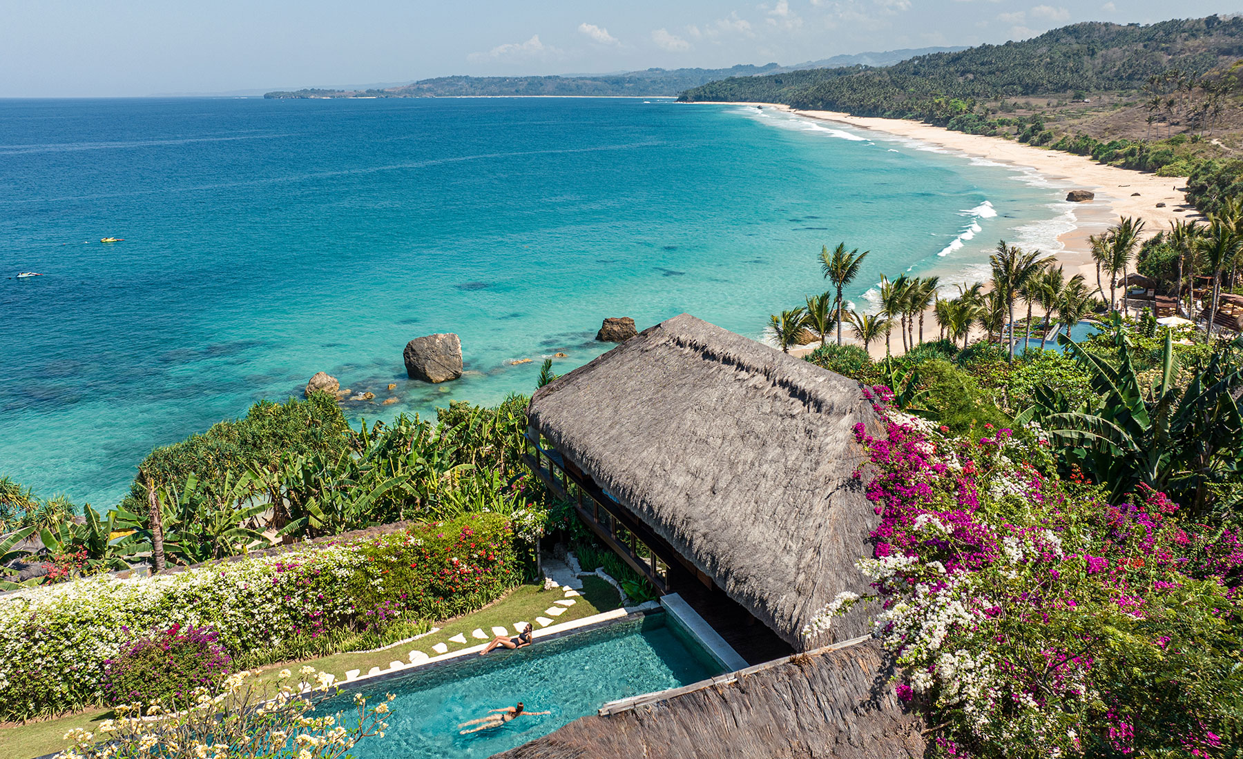 Aerial view of Raja Mandaka, Chris Burch’s private villa at NIHI Sumba, overlooking the turquoise waters of the Indian Ocean and the resort’s 2.5 km stretch of white sand beach, surrounded by lush tropical greenery