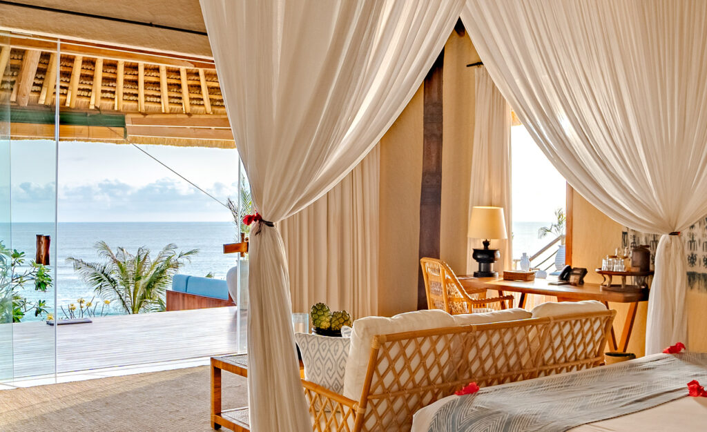 Putri Kasambi Villa featuring an elegant bedroom with ocean views, blending tropical luxury and serene comfort.