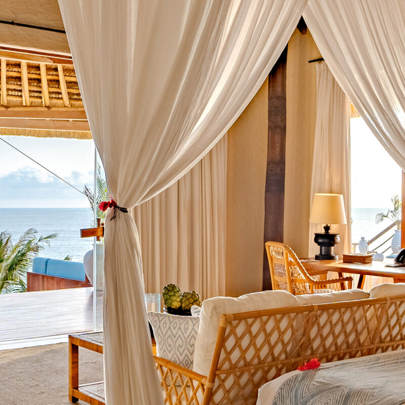 Putri Kasambi Villa featuring an elegant bedroom with ocean views, blending tropical luxury and serene comfort.