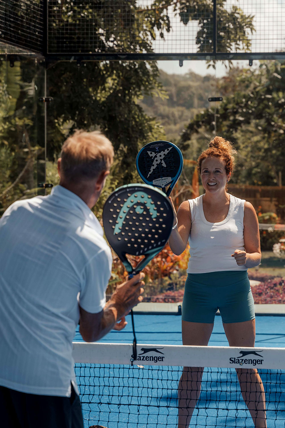 Guest teaching a women how to play padel at NIHI Sumba’s tropical court, part of the resort’s Active Wellness offerings designed to inspire movement, connection, and fun for all ages.