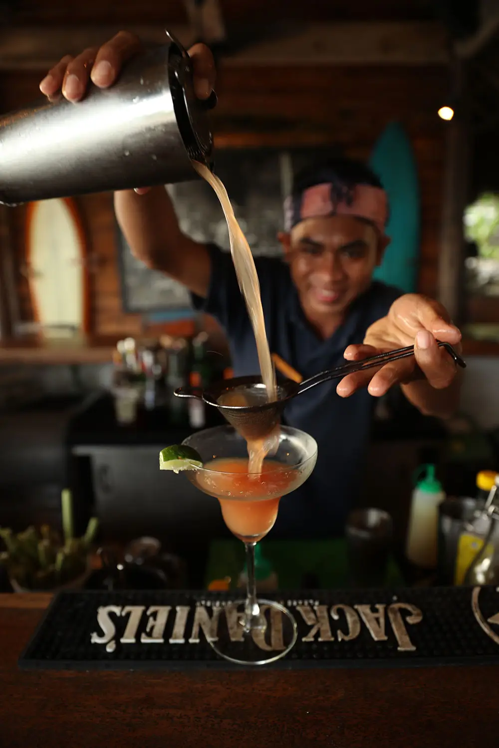 Bartender at Boathouse Bar preparing a refreshing sorbet cocktail, garnished with mint.