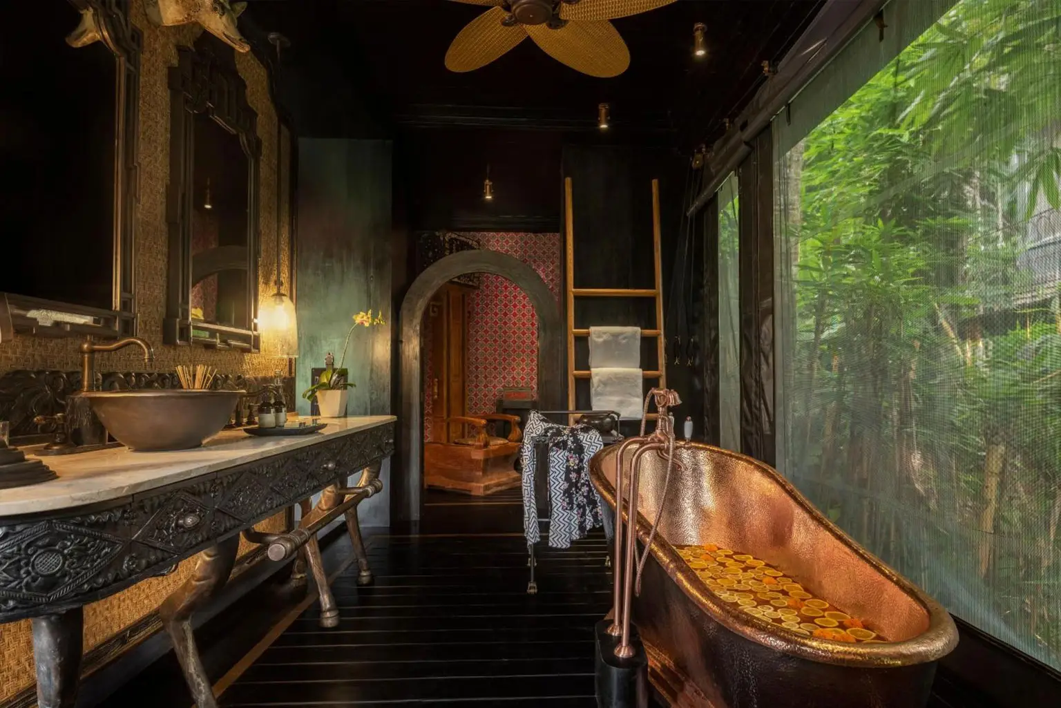 Luxurious bathroom at Capella Ubud, featuring elegant design elements surrounded by tropical rainforest views—part of the 'Awaken to Magic' journey in collaboration with NIHI Sumba.