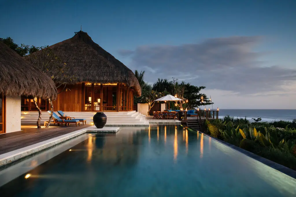 Sunset at Raja Mandaka Villa with private infinity pool overlooking the ocean at NIHI Sumba, Indonesia.