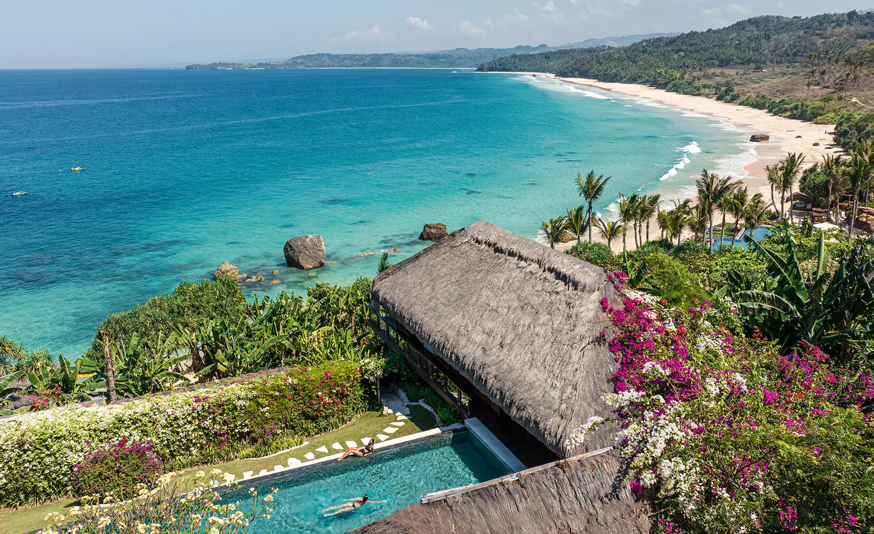 Aerial view of Raja Mandaka, Chris Burch’s private villa at NIHI Sumba, overlooking the turquoise waters of the Indian Ocean and the resort’s 2.5 km stretch of white sand beach, surrounded by lush tropical greenery