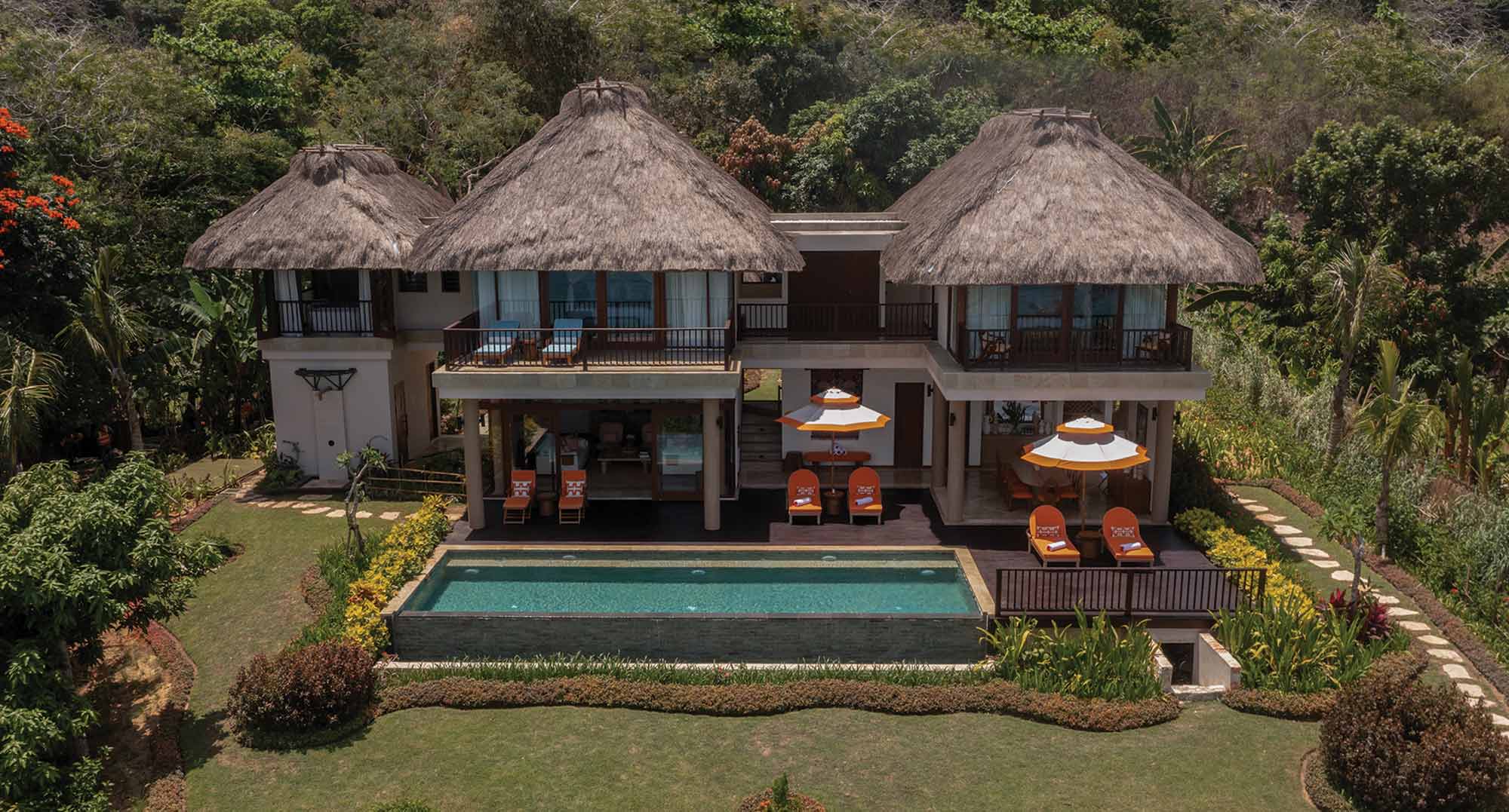 Aerial view of the new three-bedroom villa featuring two bedrooms upstairs, an outdoor dining area, and a children’s bedroom with an air-conditioned living area downstairs. The villa also offers a private pool and spacious lounge deck.